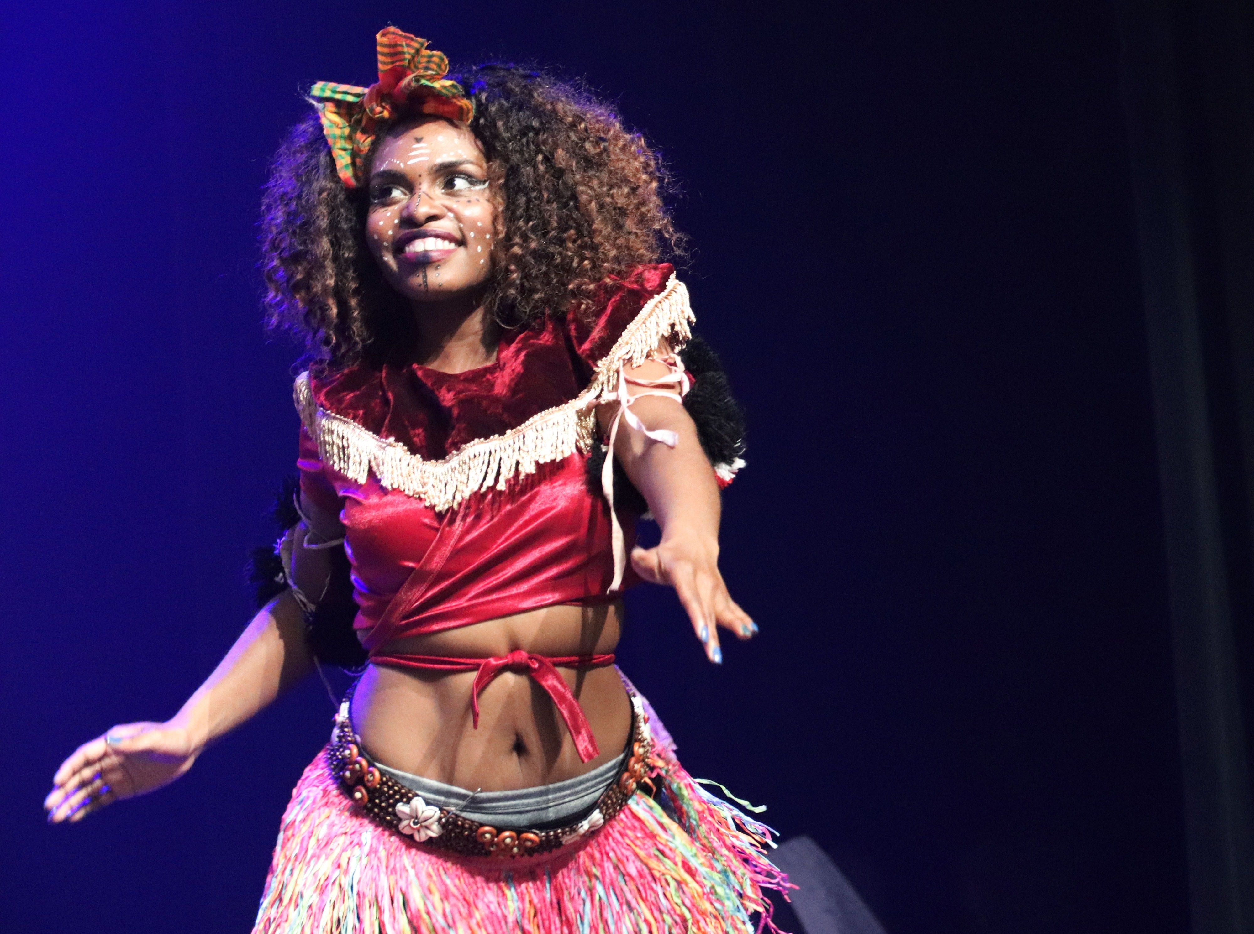 Performers in vibrant costumes at outdoor event