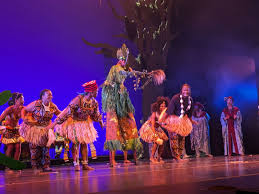 Siren performers in raffia costumes on stage at BAM DanceAfrica 2024
